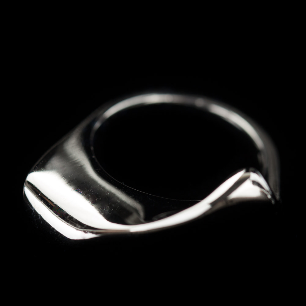 Silver polished ring with an irregular shape