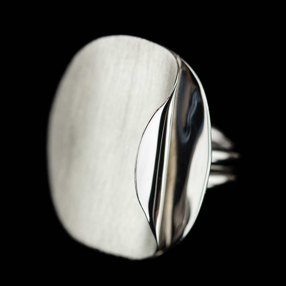 Silver circular ring with polished curl