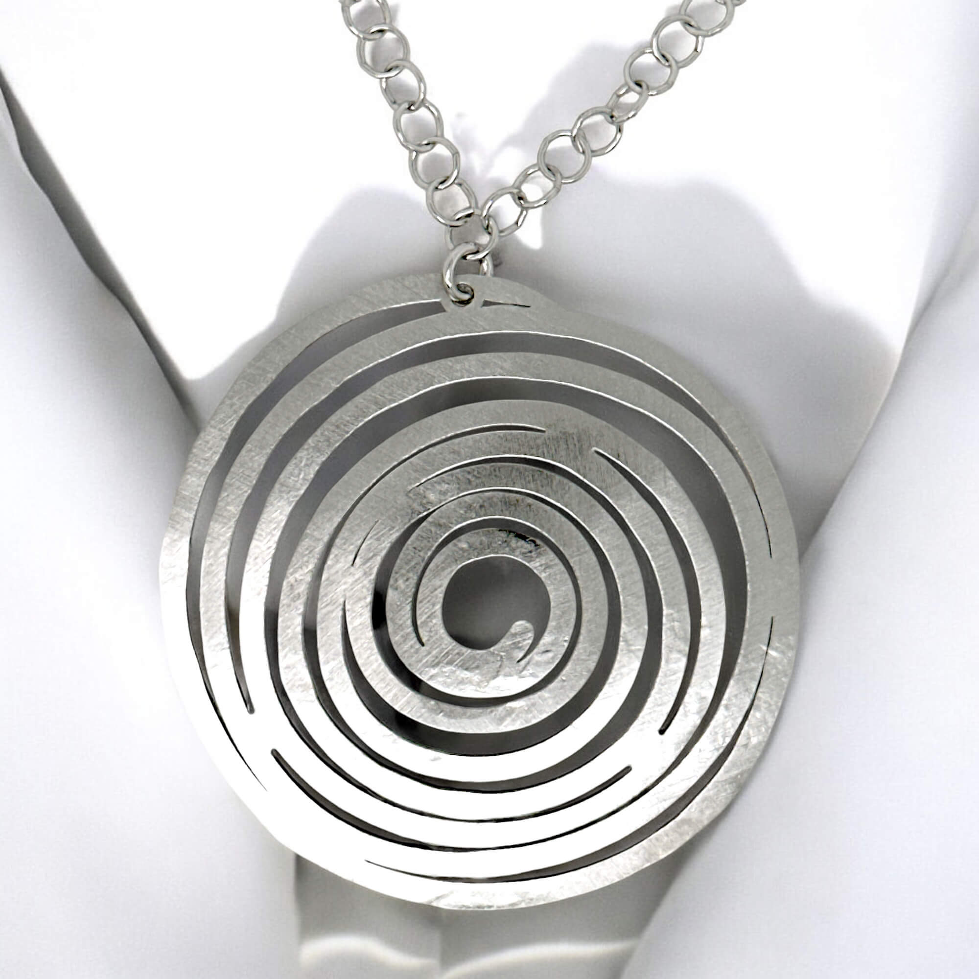 Circular silver pendant with chain