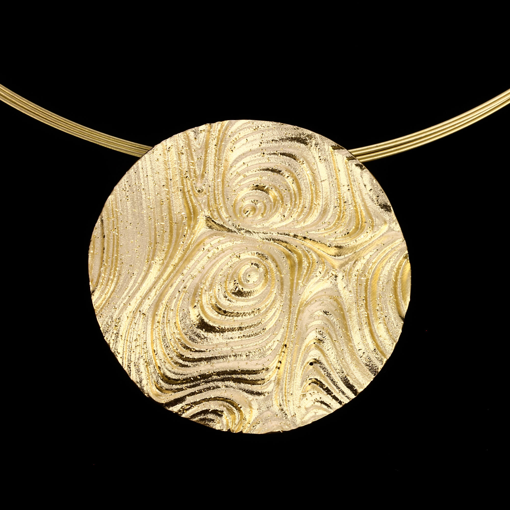 Created round pendant of gold-plated silver