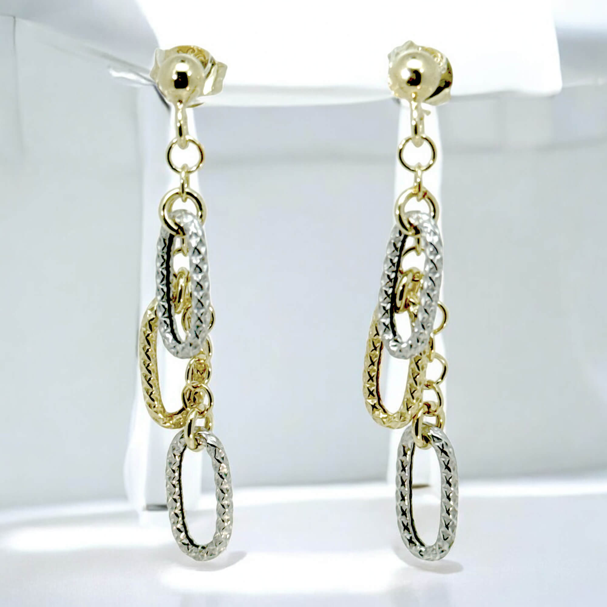 Decorated gold-plated earrings with two-tone pendants