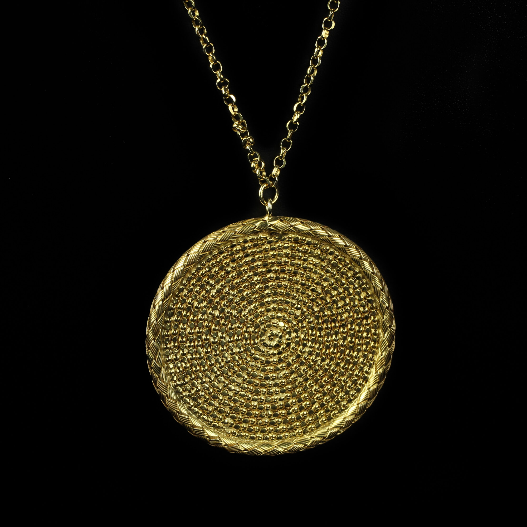 Long gold necklace with a round pendant