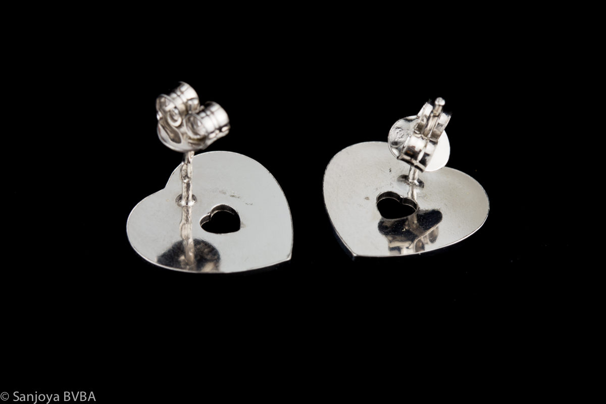 Silver heart shaped studs with mother of pearl
