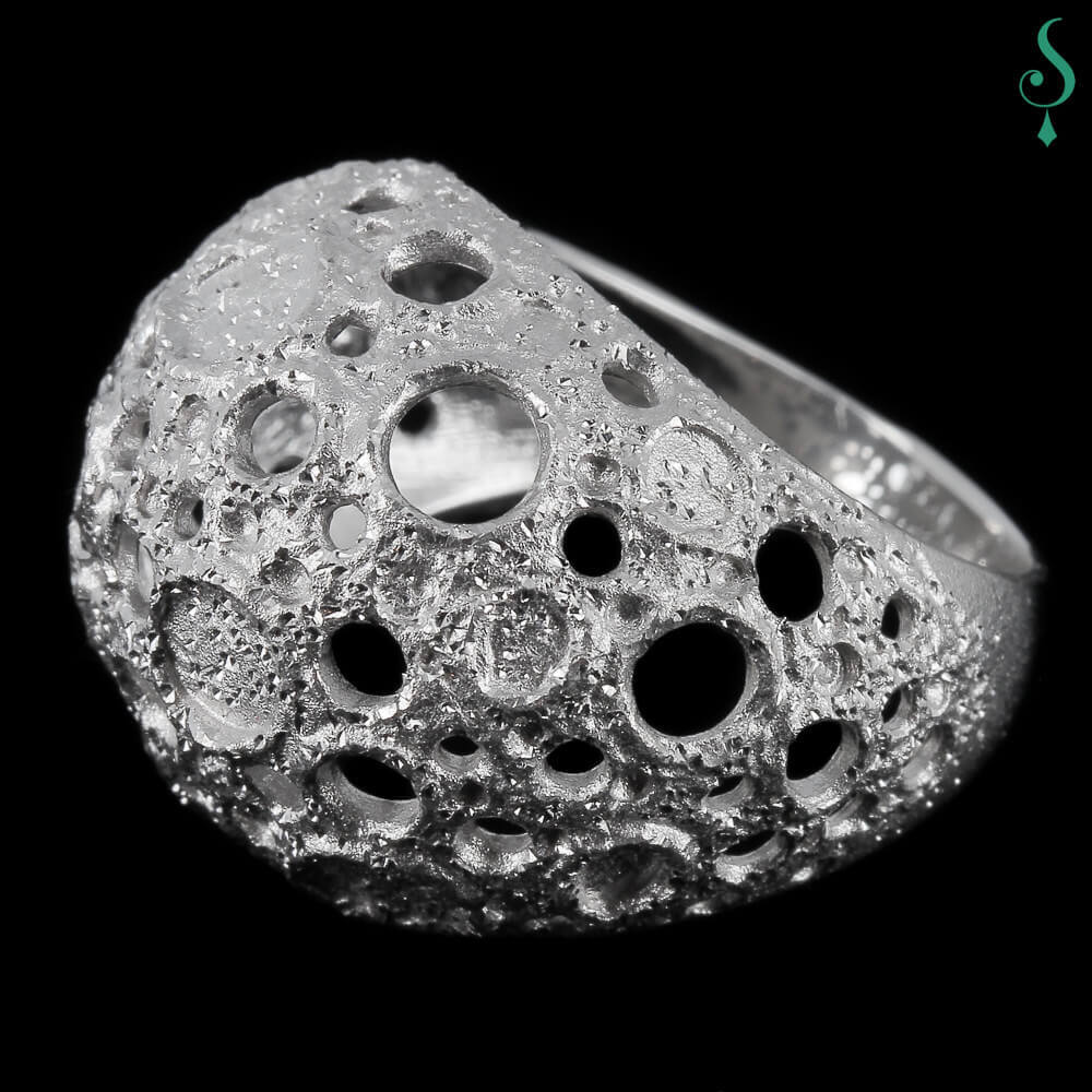 Processed and silver spherical ring