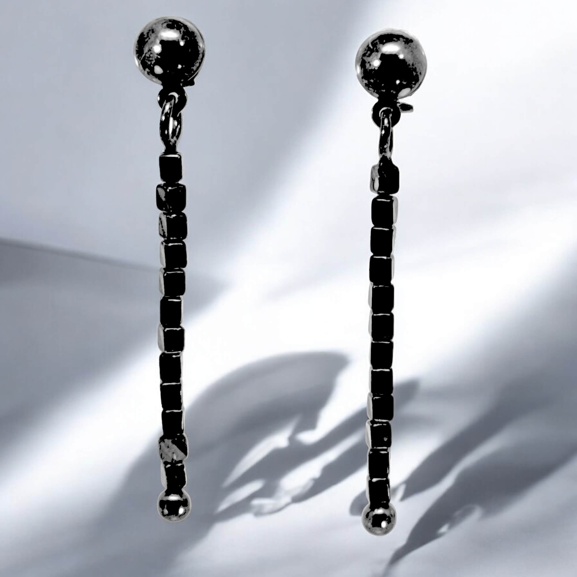 Long block earrings made of hematite